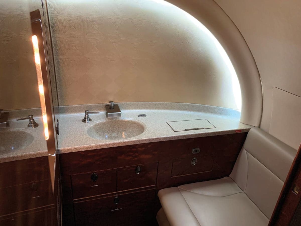 Aircraft lavatory with sink and vanity.