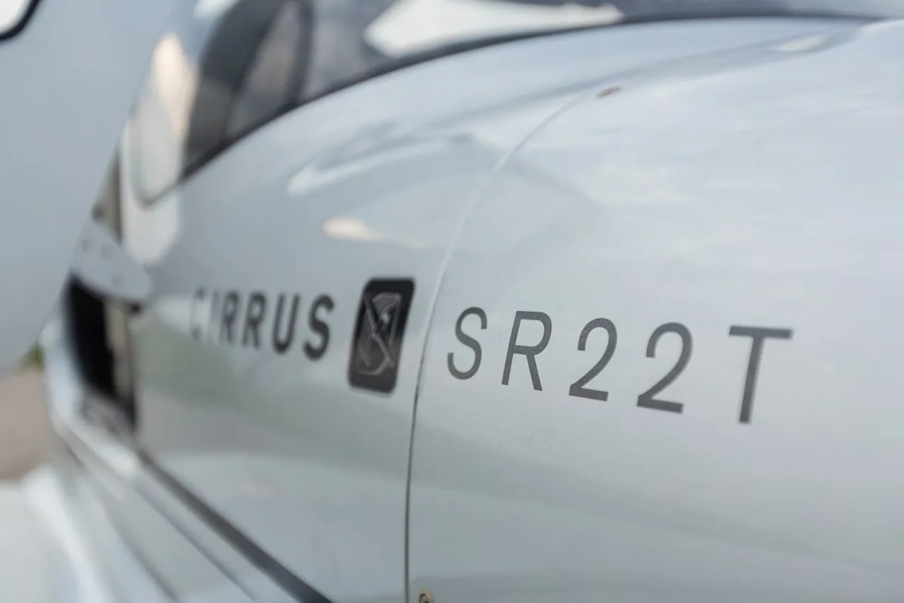 Close-up of the Cirrus SR22T logo on the aircraft's exterior.