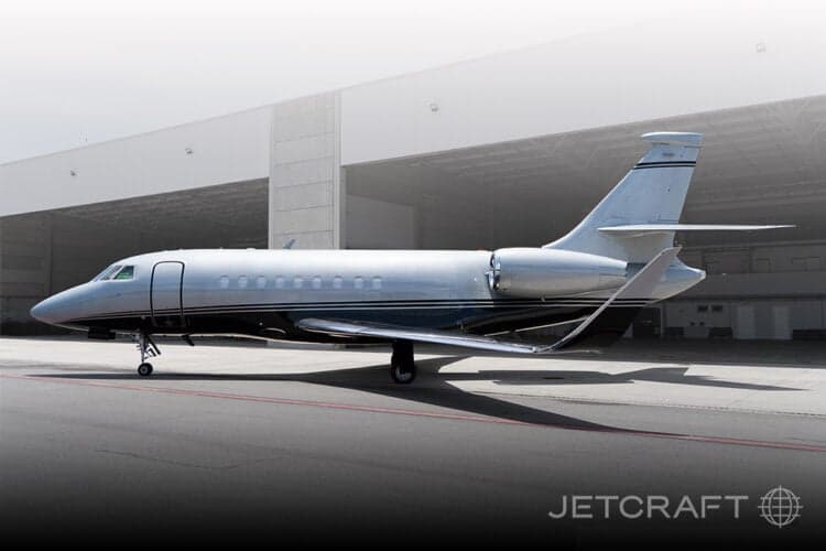 Aircraft parked on the tarmac in front of a hangar.