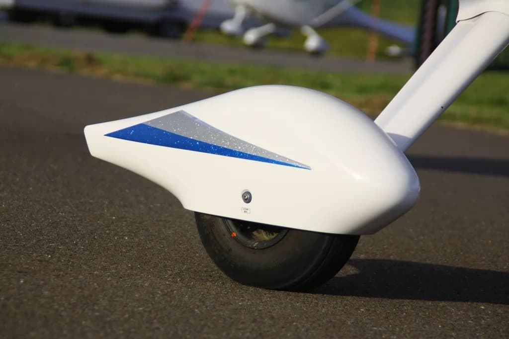 Close-up of the wheel fairing on a REMOS GX aircraft.