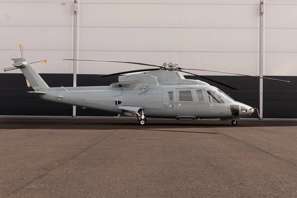 Grey helicopter parked on the tarmac.