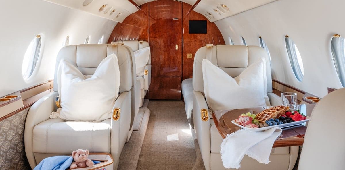 Interior view of the aircraft cabin with a table set for a meal.