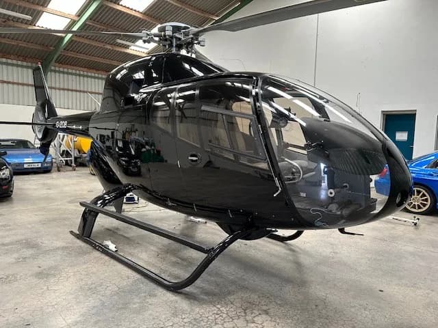 Close-up of the G-IZOB helicopter in a hangar.