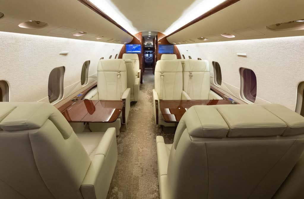The interior of the Bombardier Challenger 300 features comfortable seating and luxurious amenities.