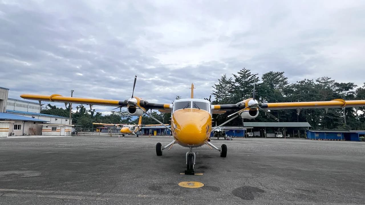 Front view of PK-OCF Twin Otter parked on the tarmac.