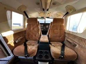The interior of the aircraft features brown seats and carpet.
