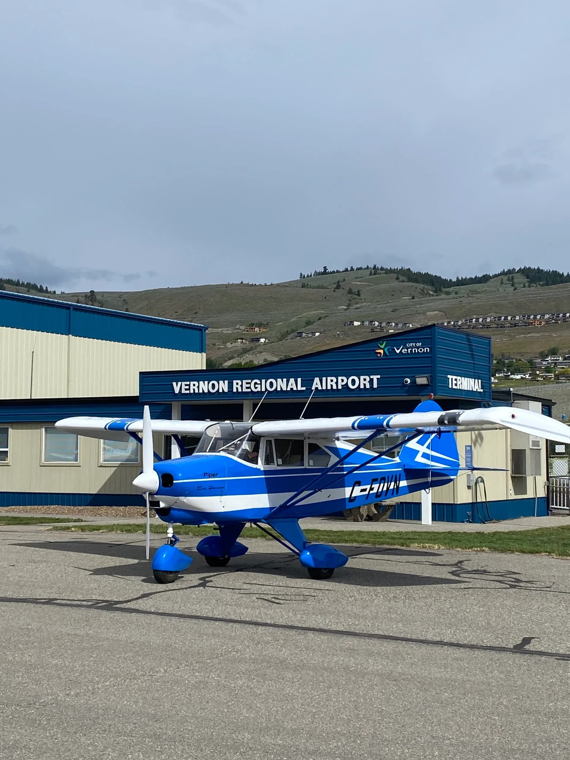 A blue and white Piper Tri-Pacer aircraft parked at Vernon Regional Airport.