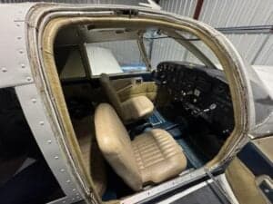 View of the aircraft's interior and cockpit from the doorway.