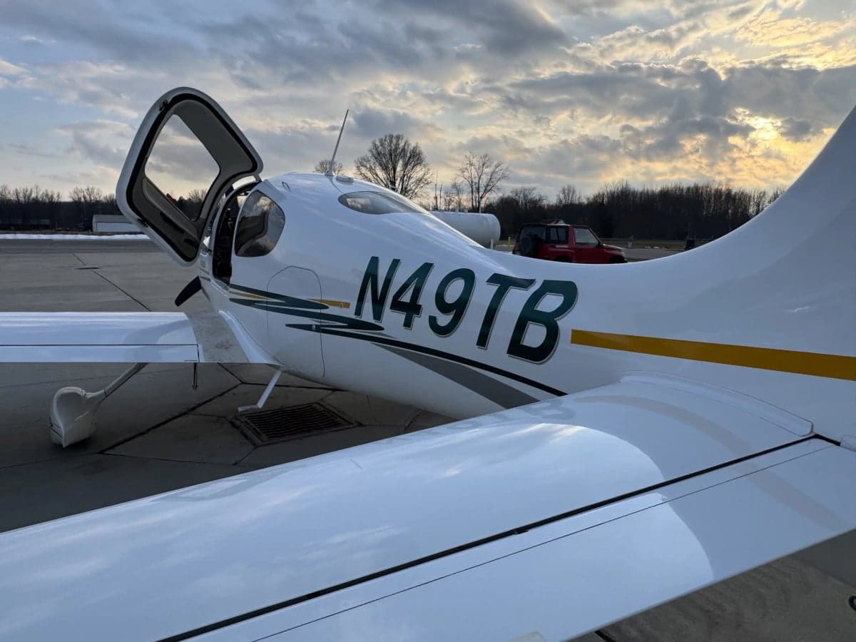 Close up of the tail of a Cirrus SR20 aircraft with open doors.