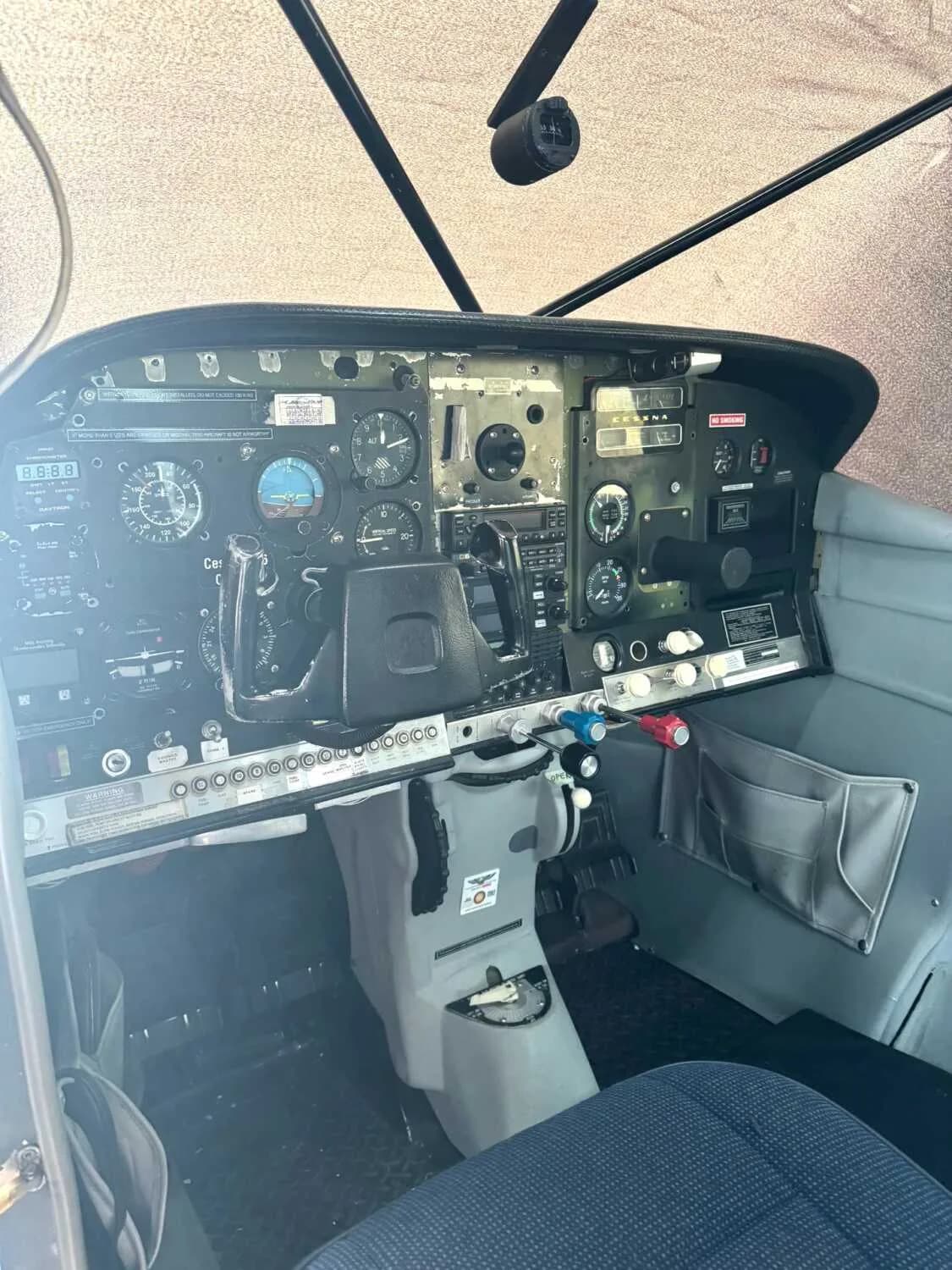 The cockpit of a Cessna 206 Stationair with a detailed instrument panel.