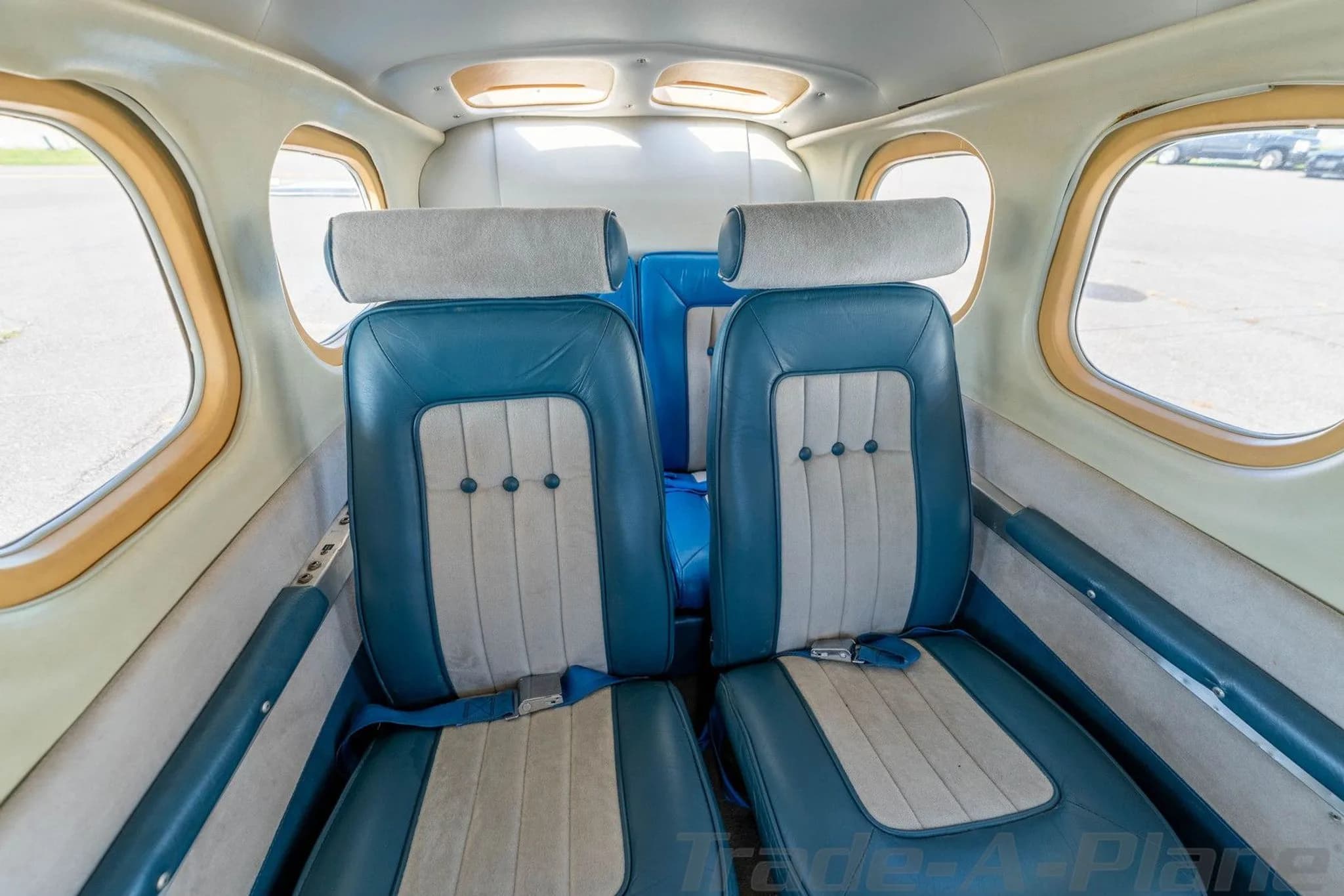 A straight-on view of the aircraft's blue and light gray passenger seats in the cabin.