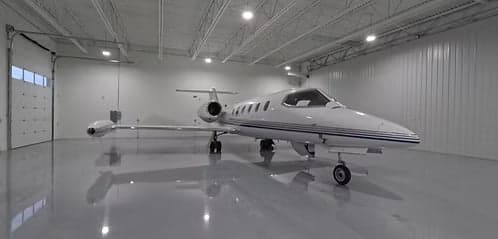 A Learjet parked inside a hangar.