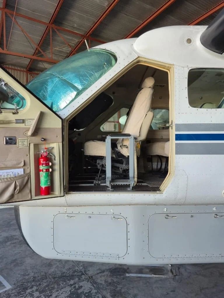 The open door and seat of the Cessna Caravan aircraft.