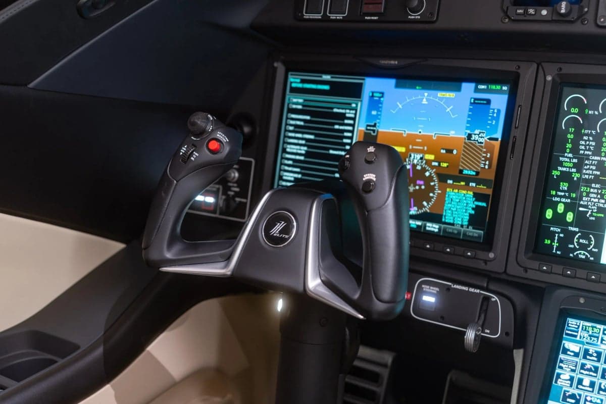 Close-up of the control stick and display screens in the HondaJet cockpit.