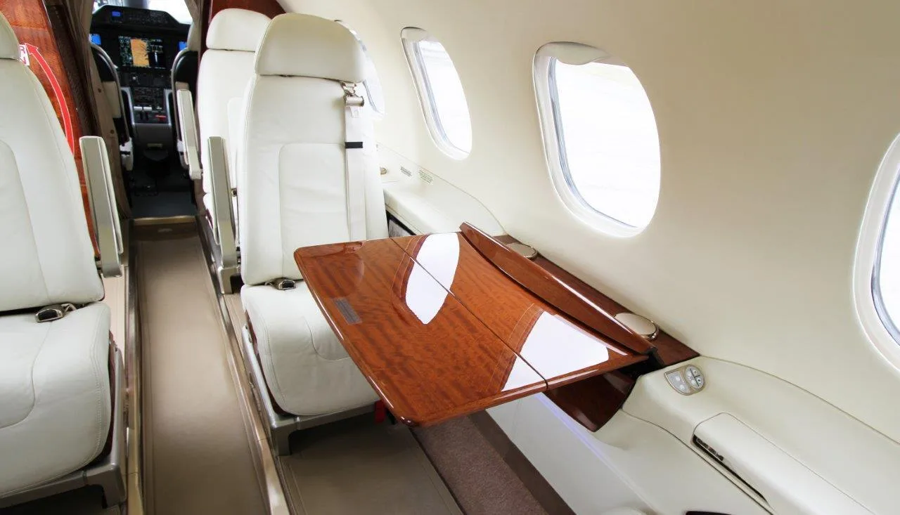 The Phenom 300E cabin features a fold-out table for work or dining.