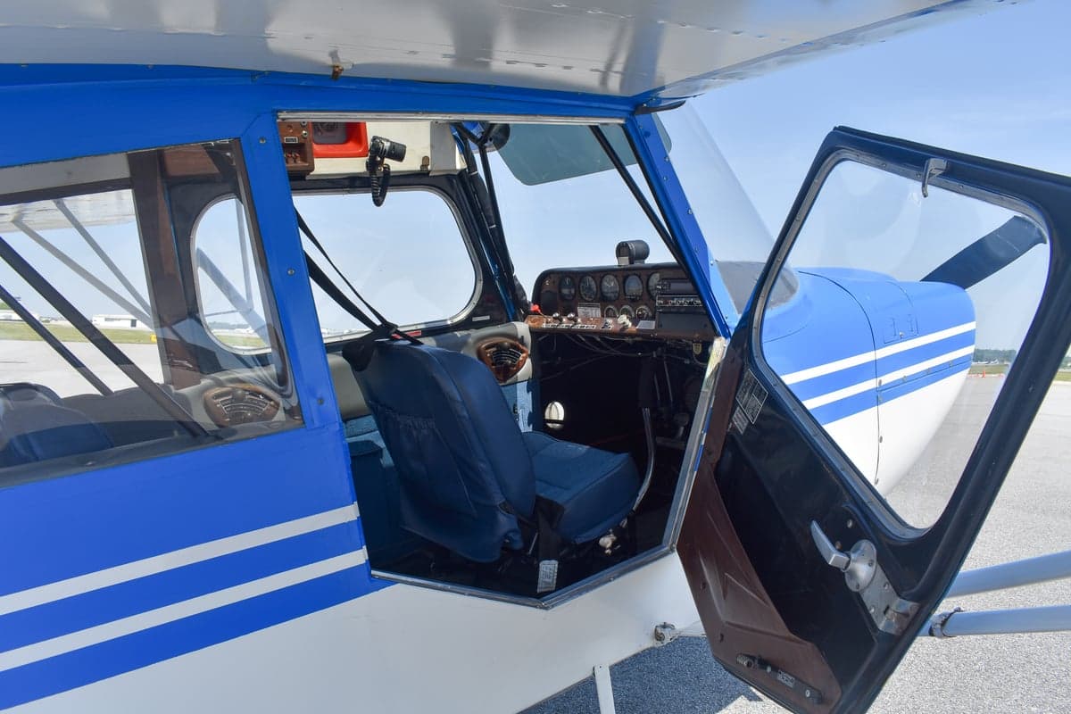 Close up of the tail of a blue and white aircraft with tail number N1034E.