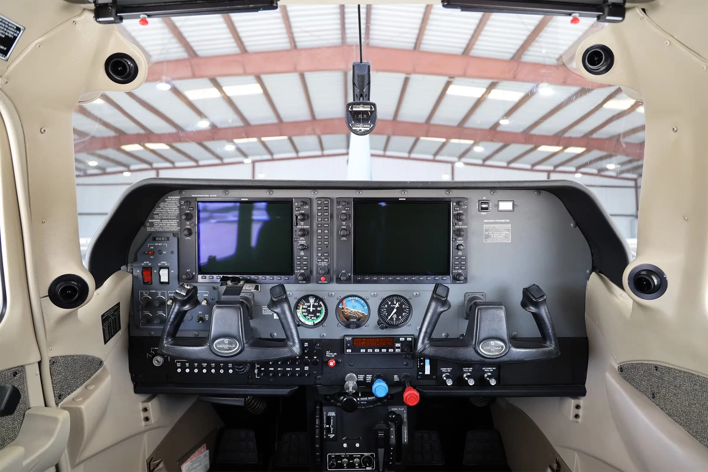 The cockpit of a Cessna 206 Stationair TC, featuring a modern glass panel with two large displays.