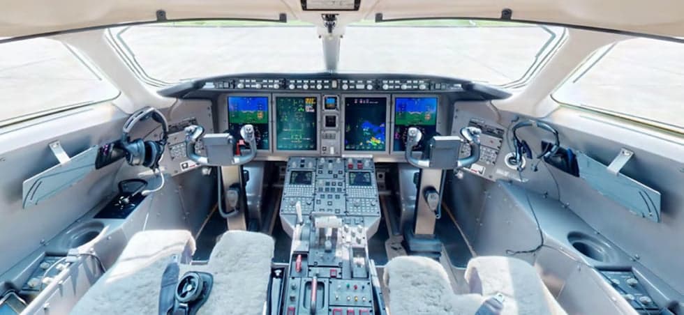 The cockpit of the Challenger aircraft features a full instrument panel and sheepskin seat covers.