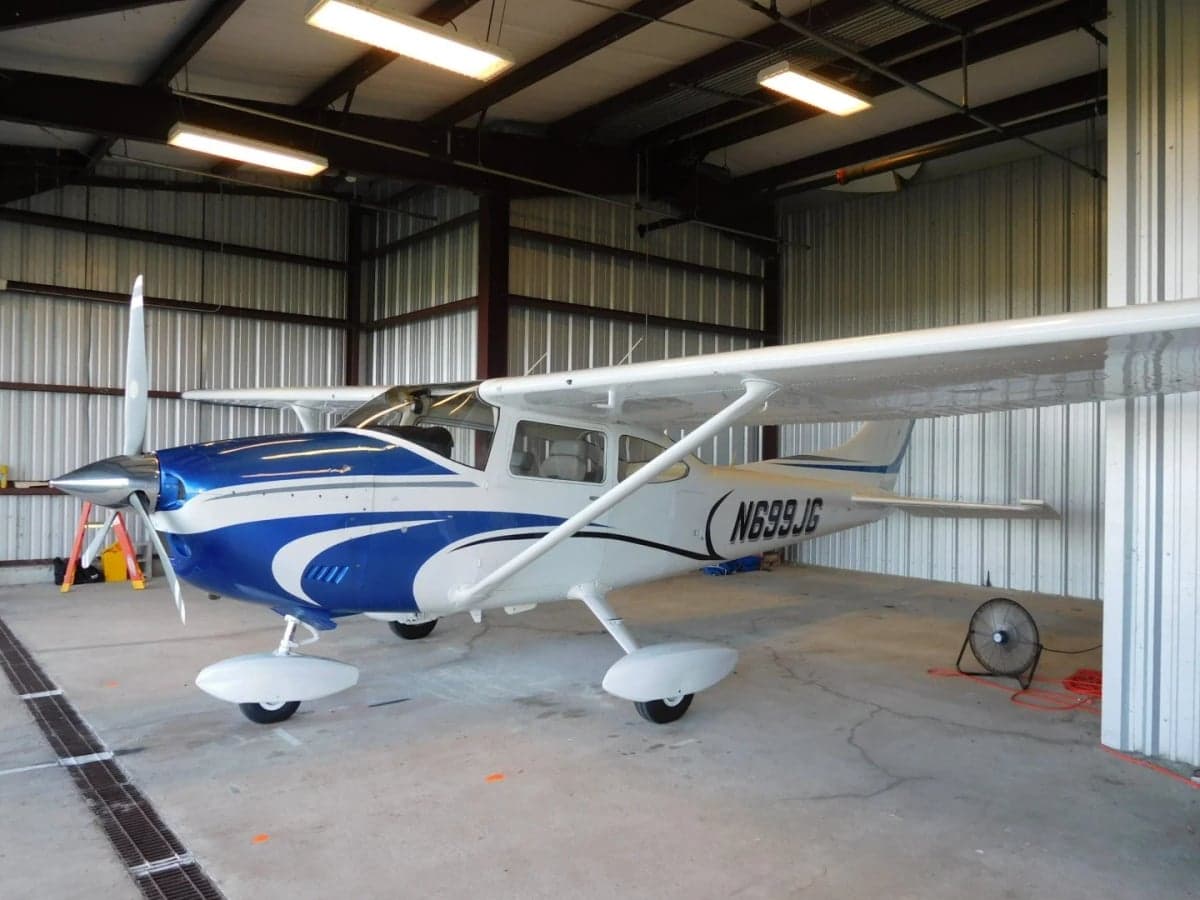 Front quarter view of the N699JG Cessna aircraft inside a hangar.