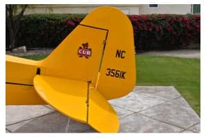 Interior view of the yellow Piper Cub showing avionics and headset.