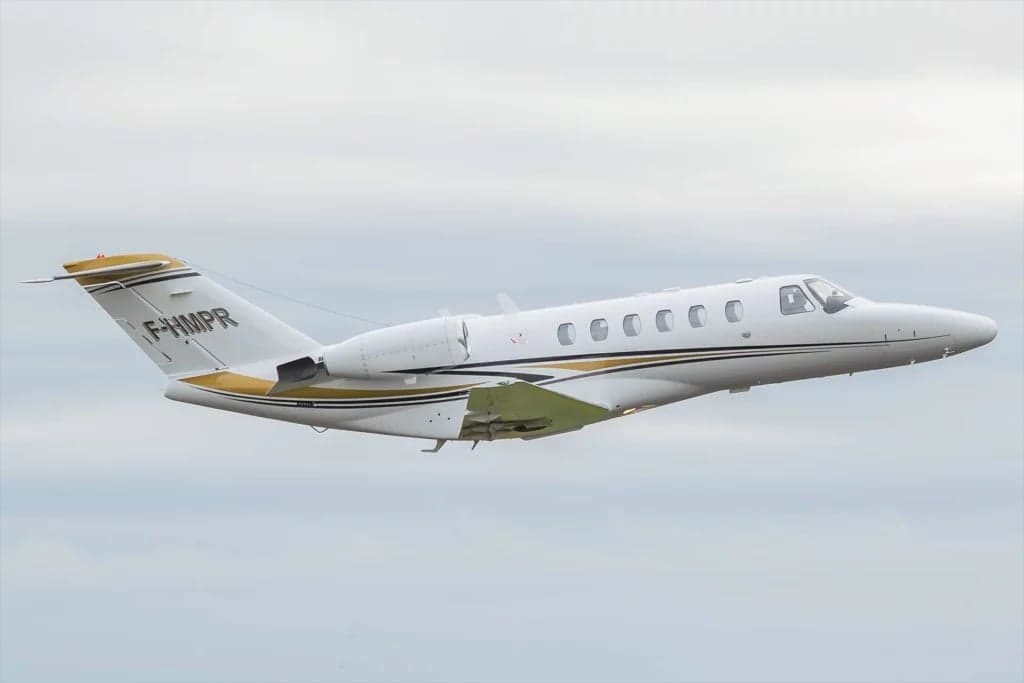 A Cessna Citation CJ2 aircraft with registration F-HMPR in flight.