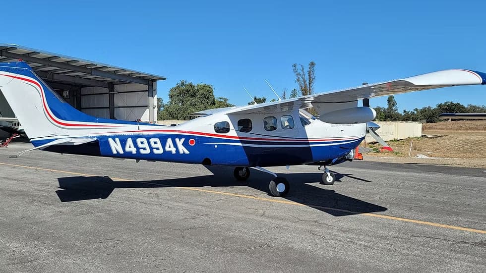 Side view of the blue and white N4994K aircraft.