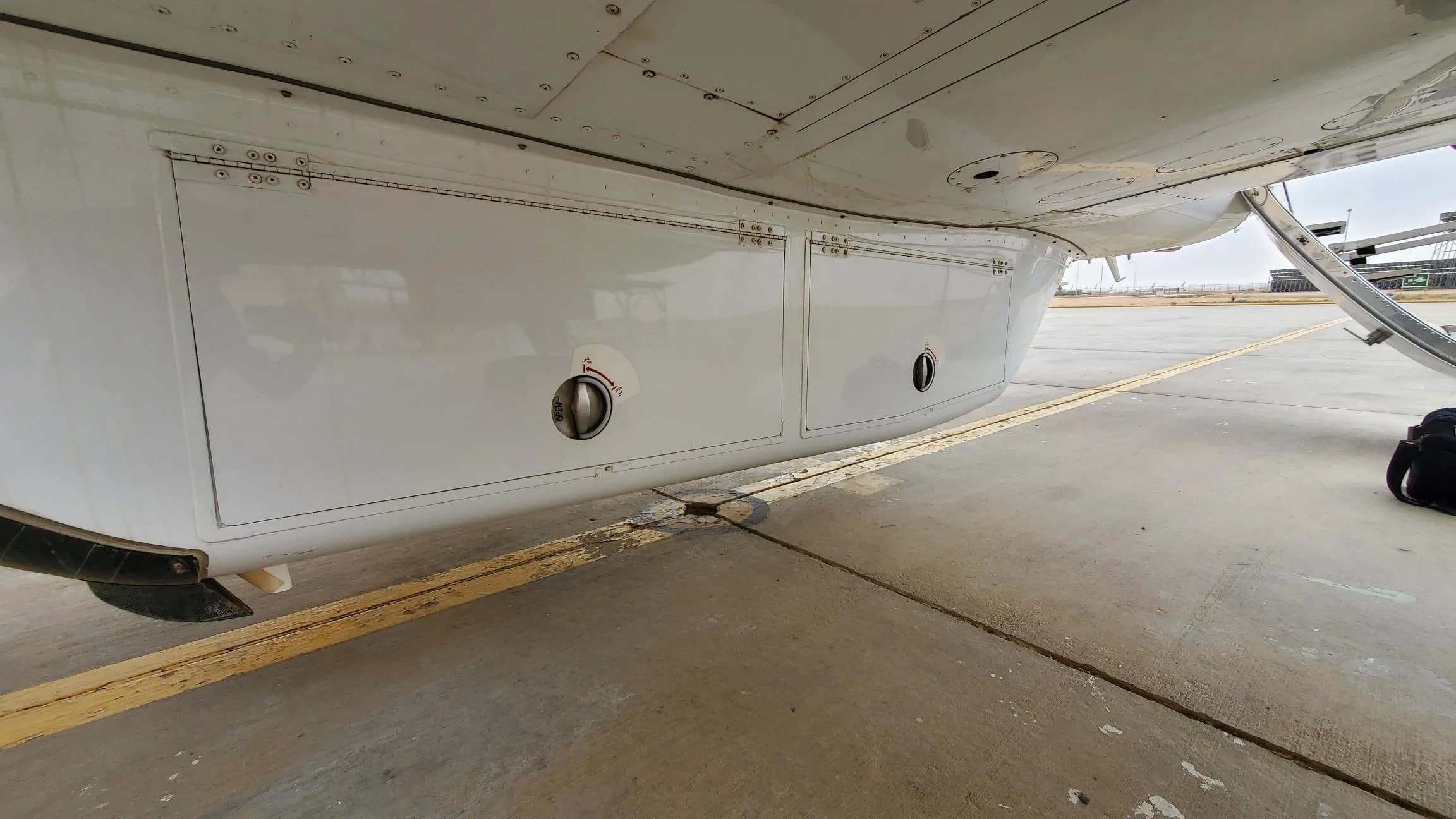Close-up of the aircraft's underside showing access panels and landing gear.