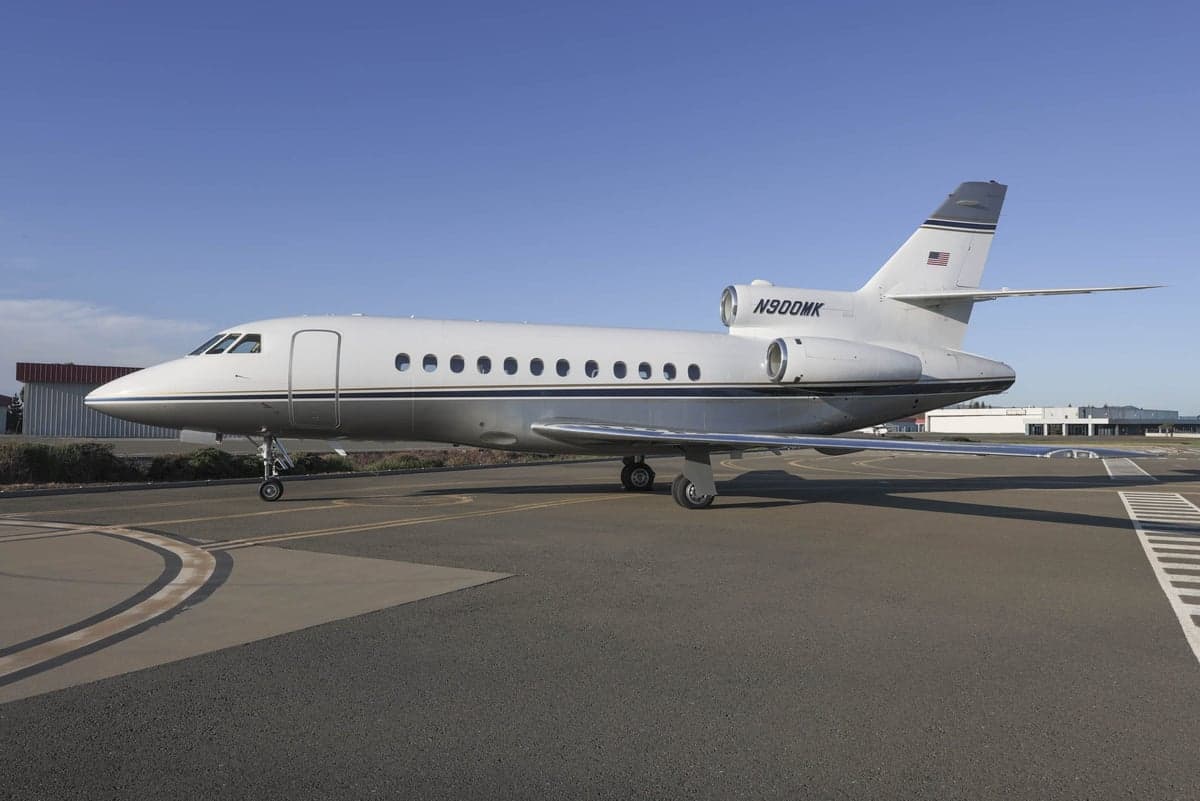 N900MK Falcon aircraft parked on the tarmac.