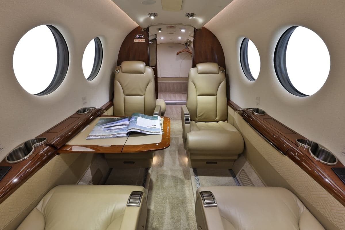 Forward view of the King Air 350 cabin interior with leather seats and table.