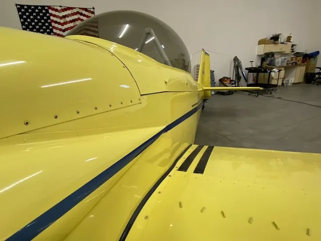 Close-up of the tail section of the yellow N639TB aircraft.