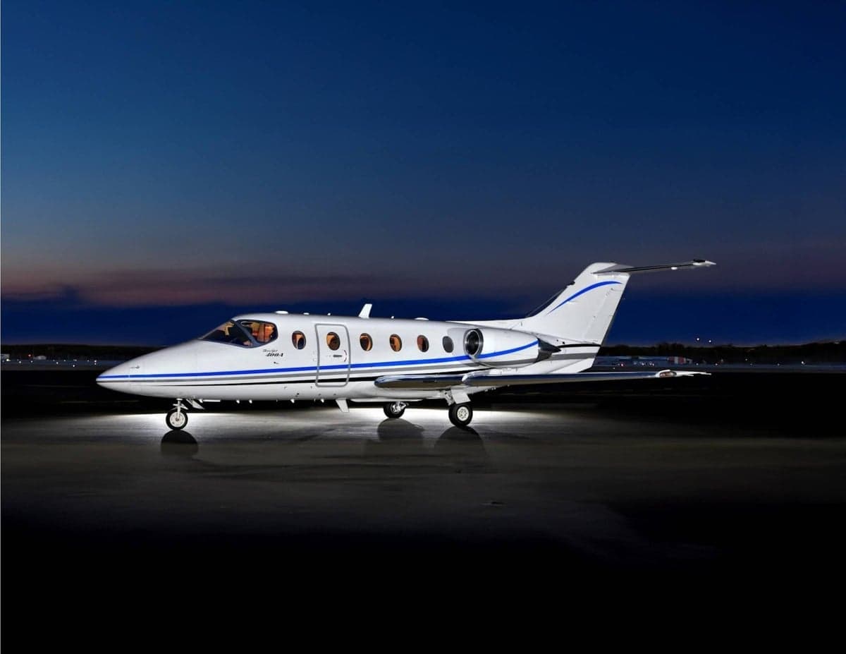 Stock photo of a Beechjet 400A on the tarmac at dusk.