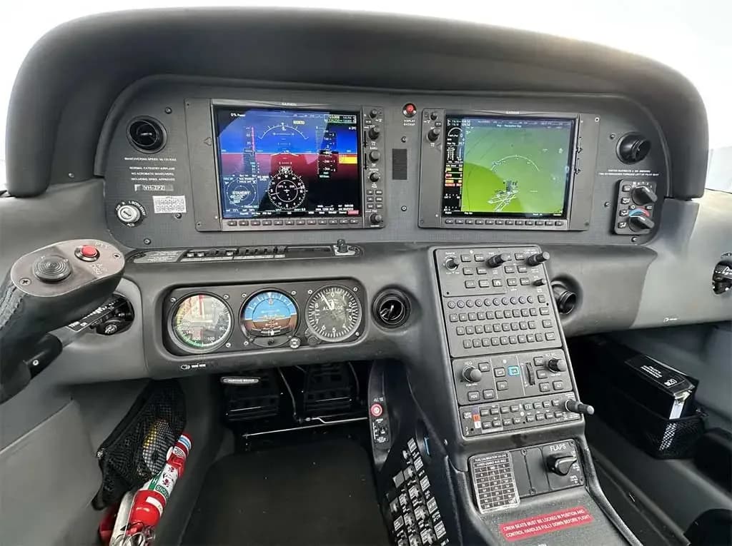 The cockpit of a Cirrus SR22 aircraft showing the Garmin G1000 glass panel displays and center console.