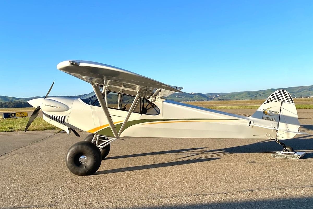 Side view of a Carbon Cub FX-3 aircraft with tail number N363SS parked on the tarmac.