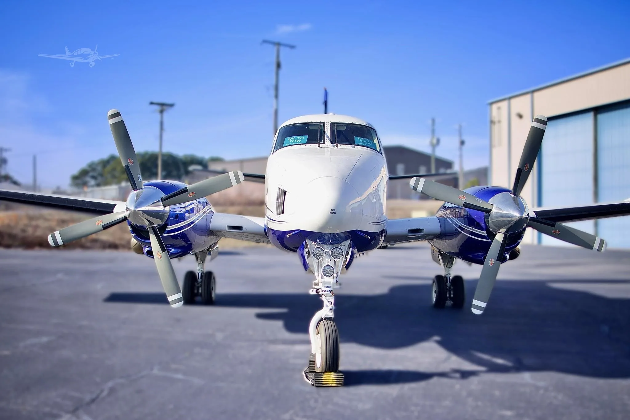 A wide-angle front view of the N222LP aircraft, highlighting its twin propellers and nose landing gear.