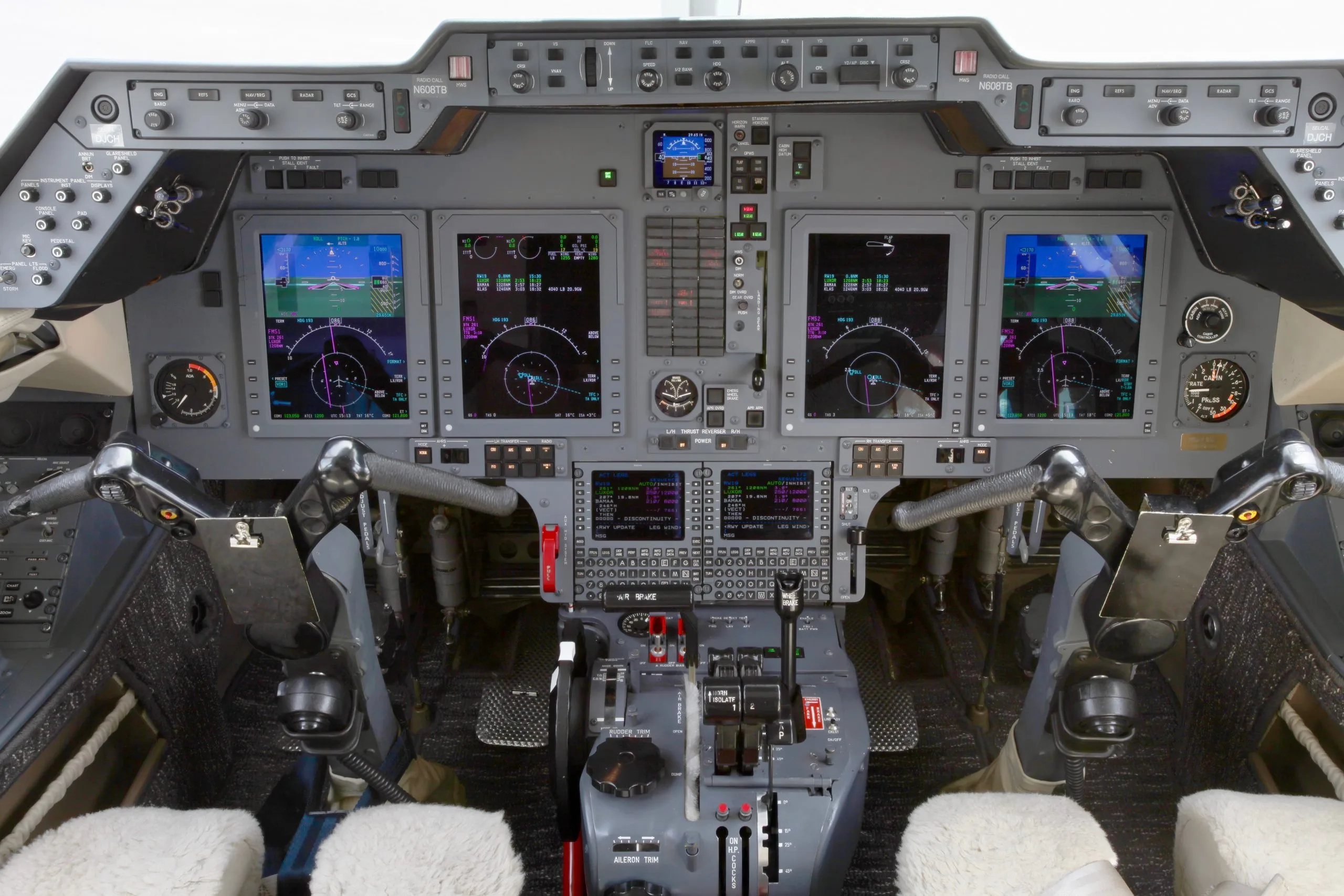 The cockpit of a Hawker 400XP aircraft with multiple display screens and controls.