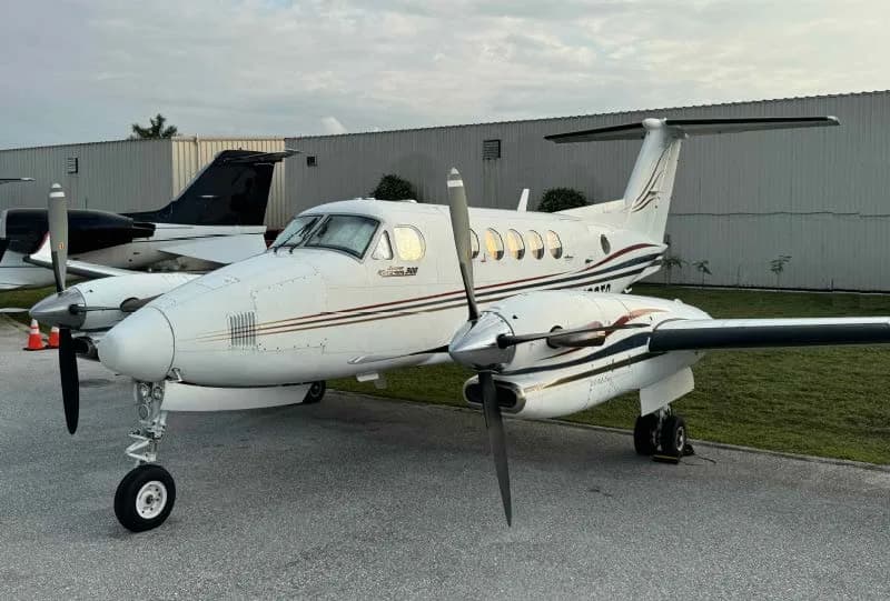 A King Air 200 aircraft with registration N66TG parked on the tarmac.