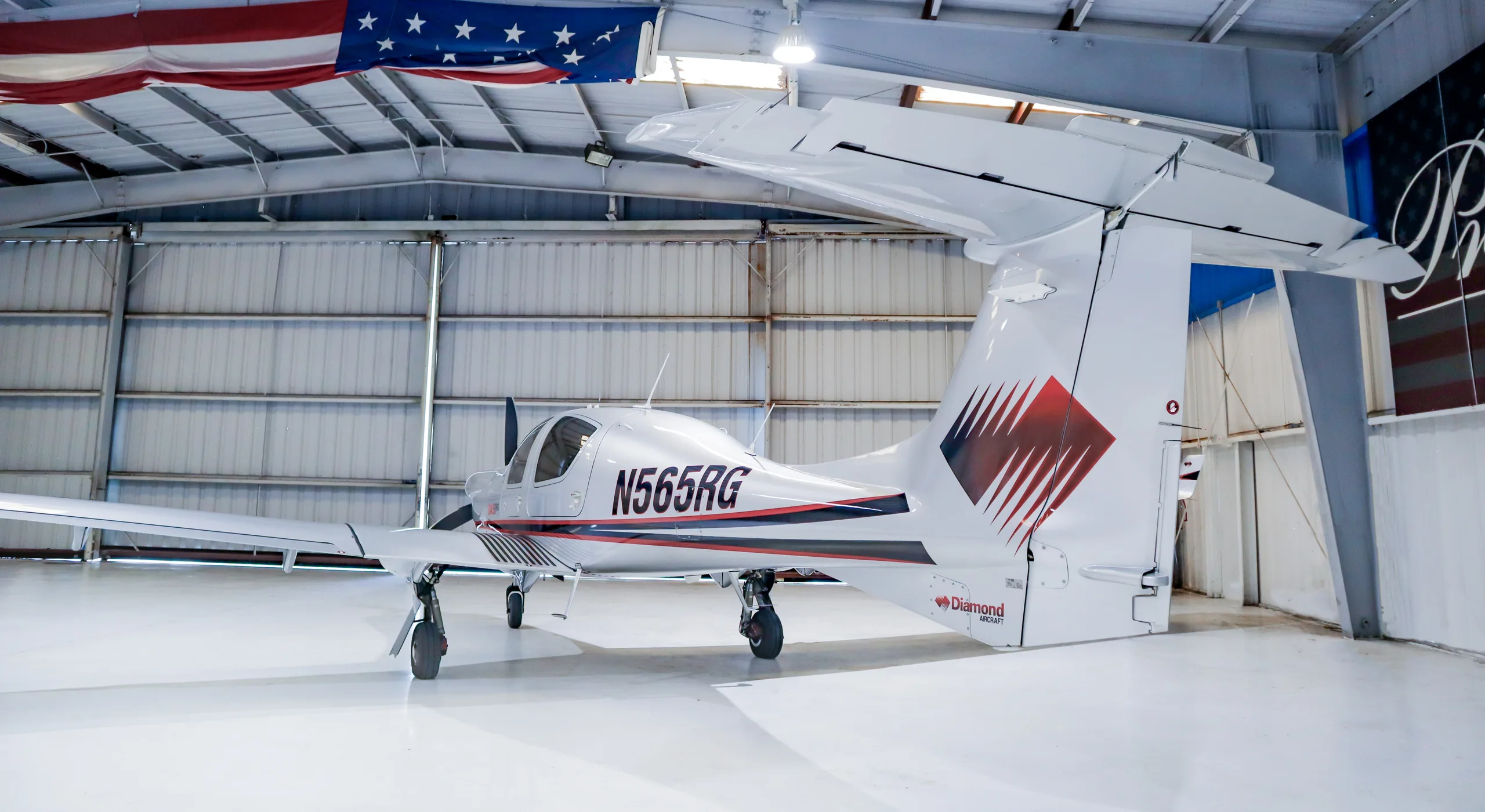 Diamond DA50RG aircraft N565RG parked in a hangar.