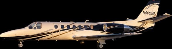 Side view of the N560EM aircraft with a black background.