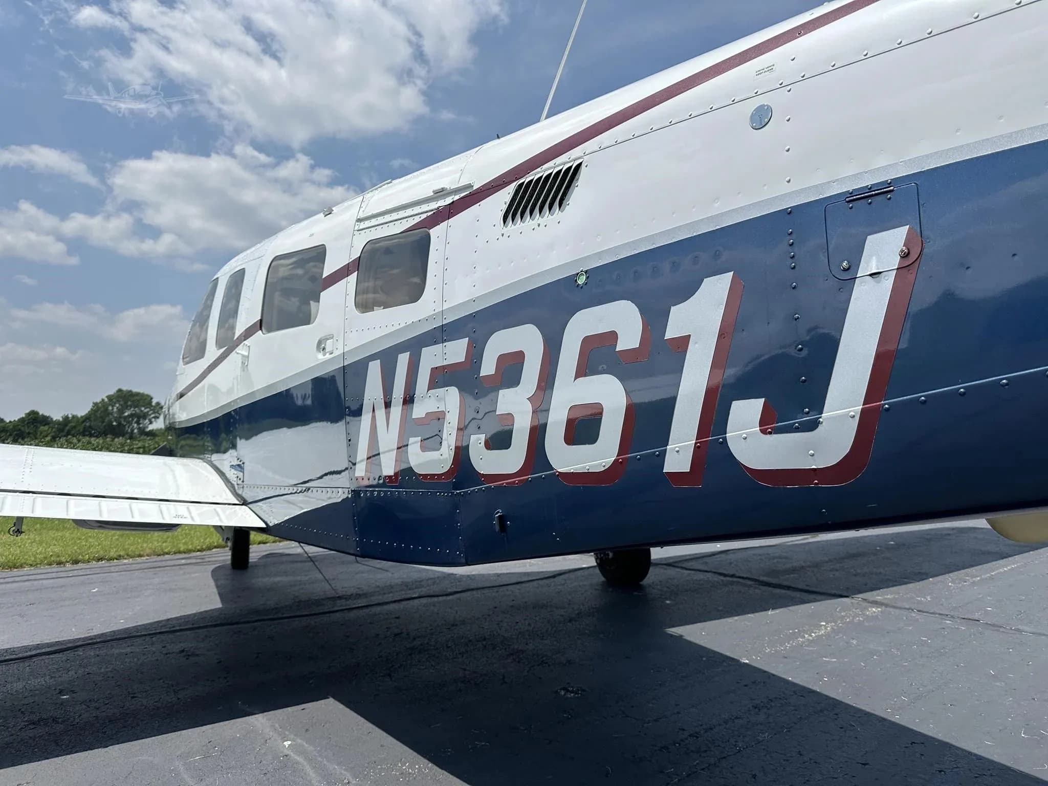 A close-up view of the N-number N5361J painted in red on the blue fuselage of the aircraft.