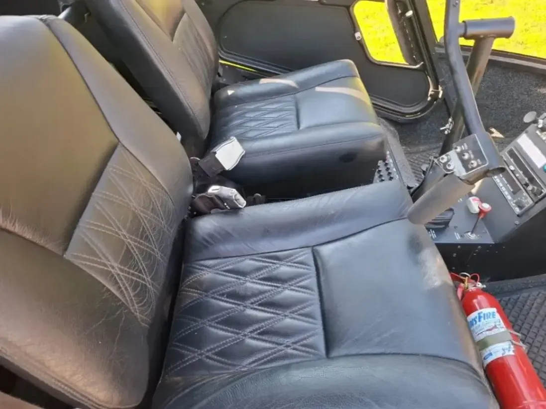 Interior view of the helicopter's black leather seats and controls.