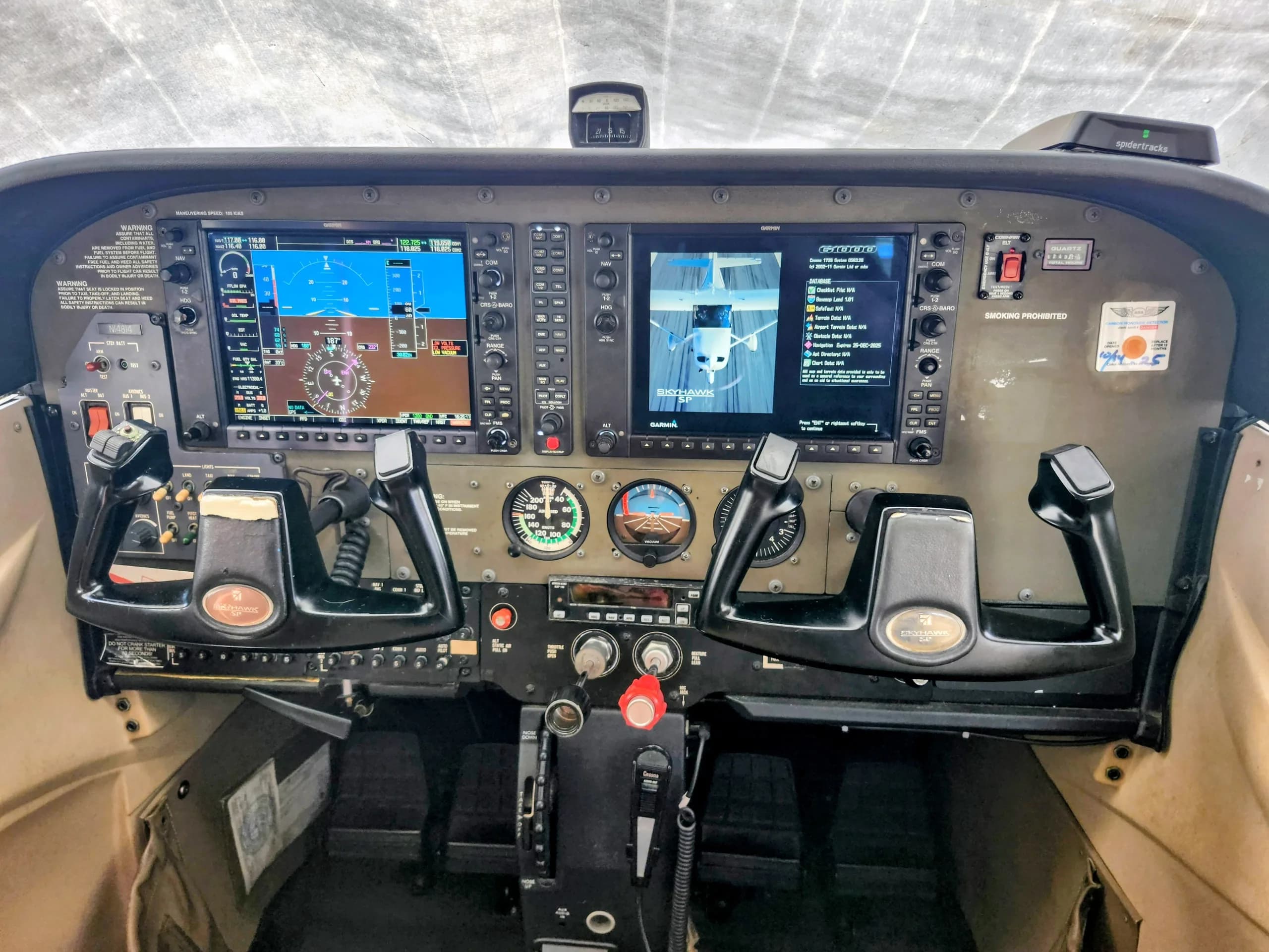 The cockpit of a Cessna Skyhawk SP features dual Garmin G1000 displays and control yokes.