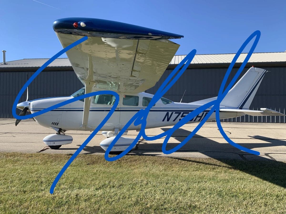 A Cessna aircraft with a blue and white paint scheme is parked on the tarmac, with the word 'SOLD' overlaid.