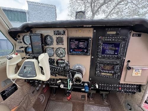 The cockpit features a variety of instruments and avionics.