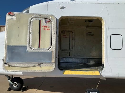 Close-up of the aircraft's open door, showing the interior and exterior.