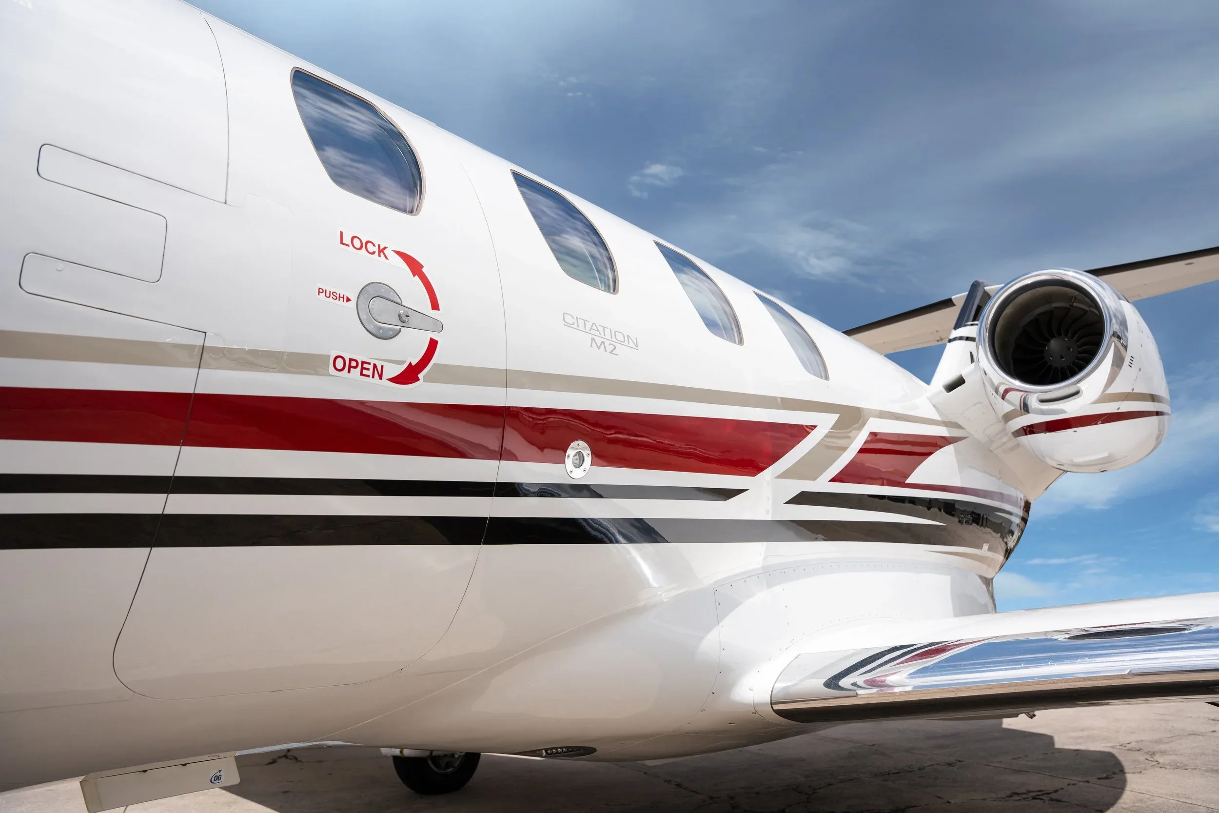 Close up of the side of a Cessna Citation M2 aircraft.