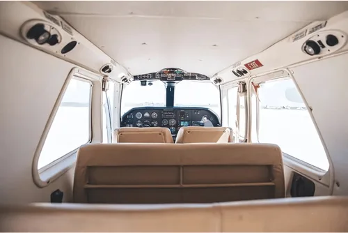 The interior of the aircraft shows the seats and cockpit.