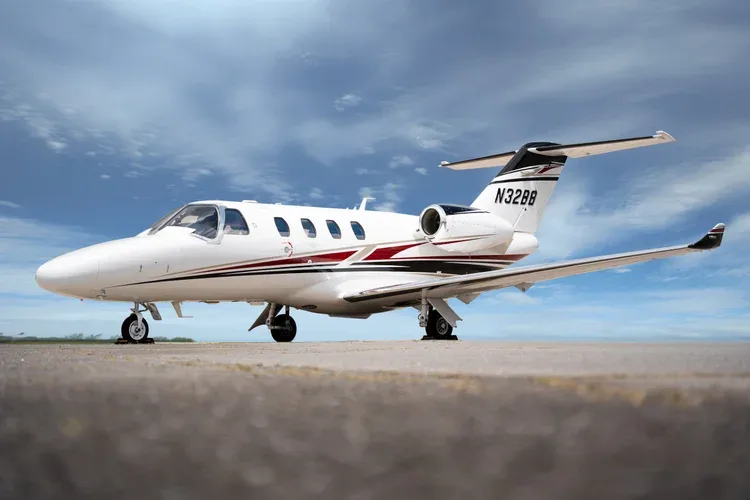 Cessna Citation M2 aircraft on the ground, side view.
