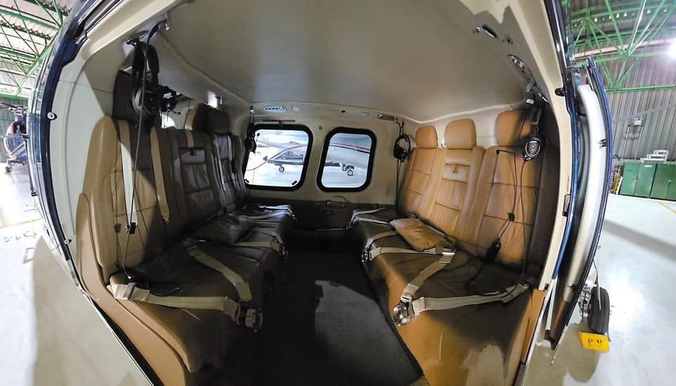 A view of the tan leather seats in the helicopter cabin.