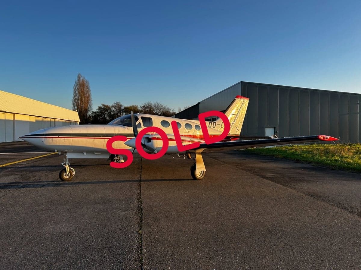 A Cessna 414 aircraft with registration OO-CJP parked on the tarmac.
