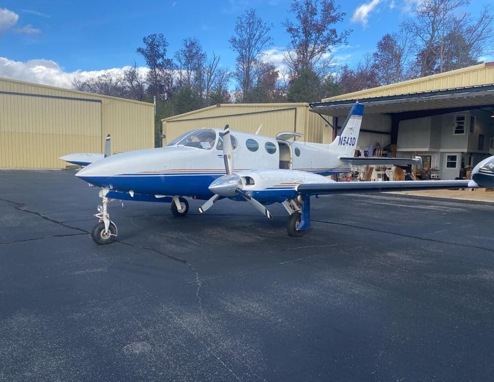 A Twin Cessna aircraft, registration N543D, parked on the tarmac.
